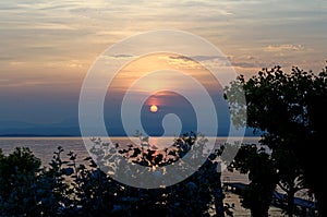 Sunset lake landscape with jetty and flies by blue hour