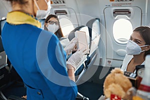 Flight attendant demonstrating product in white box to plane passenger