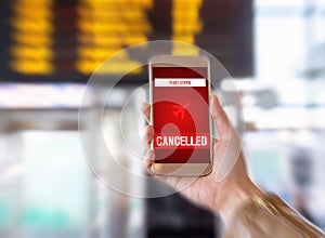 Flight cancelled. Smartphone application announces bad news to tourist. Strike or problem with plane.