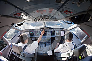 Flight Deck of modern aircraft. Pilots at work.