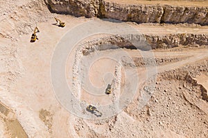 the flight of the drone over a quarry of sand and white stone,
