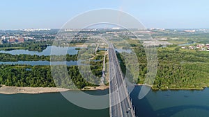 The flight of the drone over the river. The bridge over the river. Beautiful cityscape