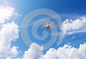 Flight drone, quadcopter on a blue sky background.