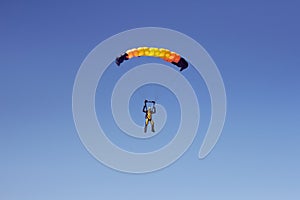 Flight of an experienced paratrooper with a professional parachute in the sky