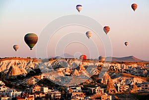 Flight of hot air balloons at dawn over a valley in Cappadocia (Turkey)