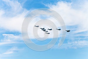 Flight military fighter aircrafts in white clouds