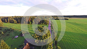 Flight over beautiful field and trees on background. Aerial rural landscape.