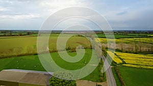 Flight over British countryside with green and yellow fields