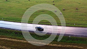 Flight over the cars. Wet road after rain. Aerial footage. Close up.