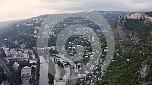 Flight over of the center city, mining town Chiatura famous for its manganese mines being situated on Kvirila river. Evening summe