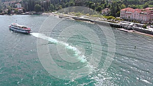 Flight over city on Maggiore lake bank