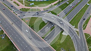 Flight over city roads. Above the multi-level road junction, you can see the movement of public transport. City aerial video