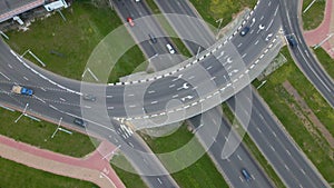 Flight over city roads. Above a multilevel road junction. Below you can see the movement of public transport. City aerial video