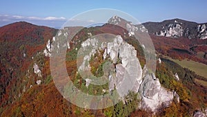 Flight over cliffs in autumn forest