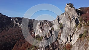 Flight over cliffs in autumn forest