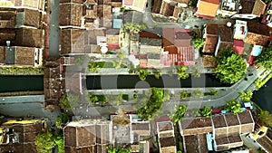 Flight over colorful roofs along channel crossing quarter