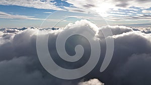 Flight over the cumulus clouds. Top view of the stunning aerial landscape.