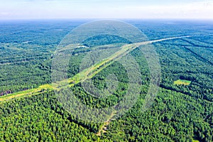 Flight over forest and power line clearing.