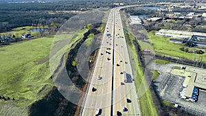 Flight over the highway and car traffic moving in the direction of the big city. Large highway with heavy traffic.