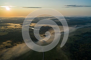 Flight over the lake forest in a foggy summer sunny morning