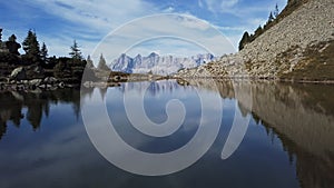 Flight over lake Spiegelsee with reflections of Dachstein, Austria