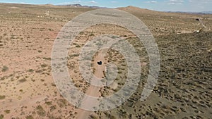 Flight over long highway at monument valley in Utah - Drone Aerial over cars in Arizona. Top view drone footage flying