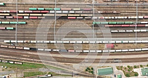flight over long railway freight trains with lots of wagons stands on parking