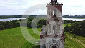 Flight over the old destroyed church surrounded by water.