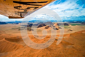 Flight over orange dunes of Sossusvlei Desert in Namib-Naukluft National Park Namibia, aerial view