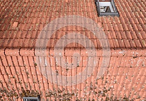 Flight over the red roof of a single family house with a chimney and a satellite antenna for inspection, control and preparation f