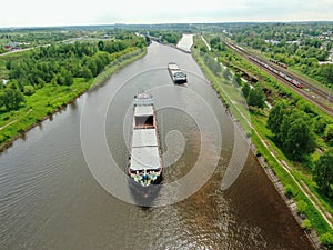 Flight over the river. Passage of hydraulic locks on the channel by commercial cargo ship