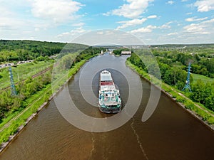 Flight over the river. Passage of hydraulic locks on the channel by commercial cargo ship