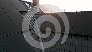 Flight over the roof of a detached house showing newly installed solar panels