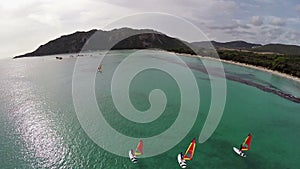 Flight over sea bay with surfers in France, Corsica, Santa Giulia beach. Aerial view.