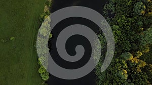 Flight over the Seim River, Ukraine surrounded by trees, view from the top - aerial videotaping