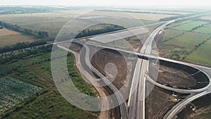 Flight over a traffic intersection. Transport interchange of highways. Road under construction. Beautiful view. A