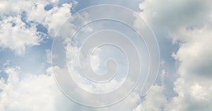 Flight over white clouds under blue sky background, seamless loop ready
