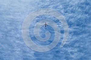 The flight of the plane against the background of the blue sky. Fast and safe transport. Migration.