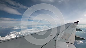 Flight of the plane on a flight level, against the background of blue sky and textural volumetric clouds. Rare clouds