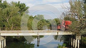 Flight by a rural bridge while two tractors are passing it