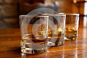 Flight of Scottish whisky, tasting glasses with variety of single malts or blended whiskey spirits on distillery tour in pub in