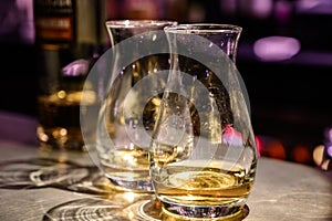 Flight of Scottish whisky, tasting glasses with variety of single malts or blended whiskey spirits on distillery tour in pub in