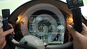 Flight simulator control panel, male hands holding airplane steering wheel