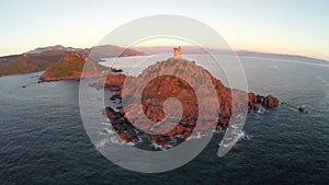 Flight and takeoff over old tower with background of the sea. Tour de la Parata, Ajaccio area, Corsica, France. Aerial v