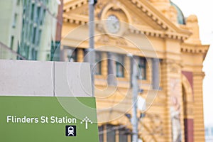 Flinders Street Station sign with Flinders Street Station in the