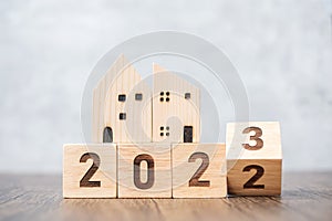 Flip 2022 to 2023 block with house model. real estate, Home loan, tax, investment, financial, savings and New Year Resolution