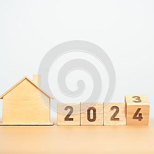 flip 2023 to 2024 block with house model. real estate, Home loan, tax, investment, financial, savings and New Year Resolution