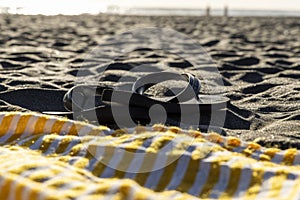 Flip-Flop sandals on black sand photo