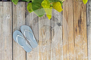 Flip Flop sandals on a sandy beach side boardwalk.  Wide angle