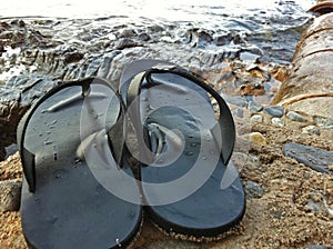 Flip flop shoes put on stone front the beach